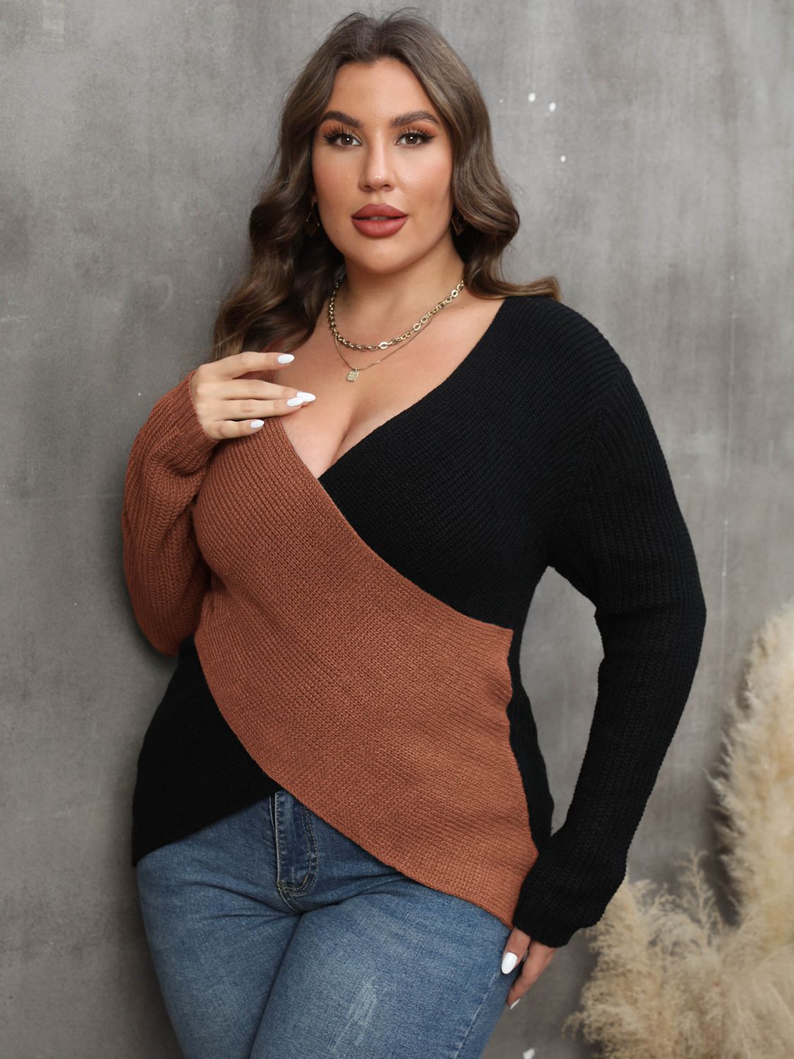Front view of a model showcasing the V-neck and colorblock design of the caramel sweater. 