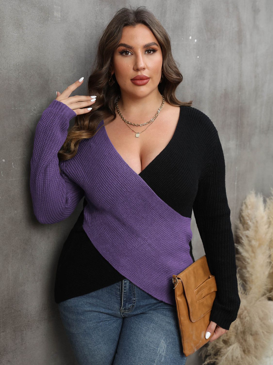 Front view of a model showcasing the V-neck and colorblock design of the violet sweater.
