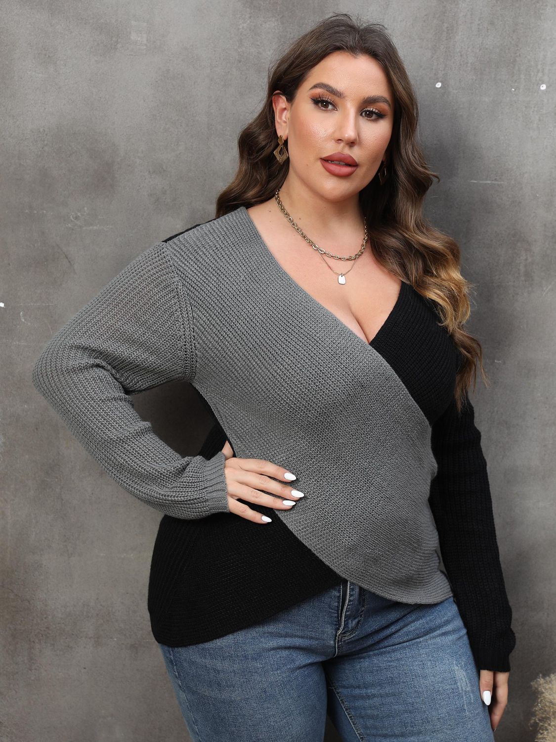 Front view of a model showcasing the V-neck and colorblock design of the grey sweater.
