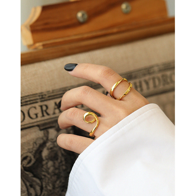 Model finger wearing heart knot silver gold ring