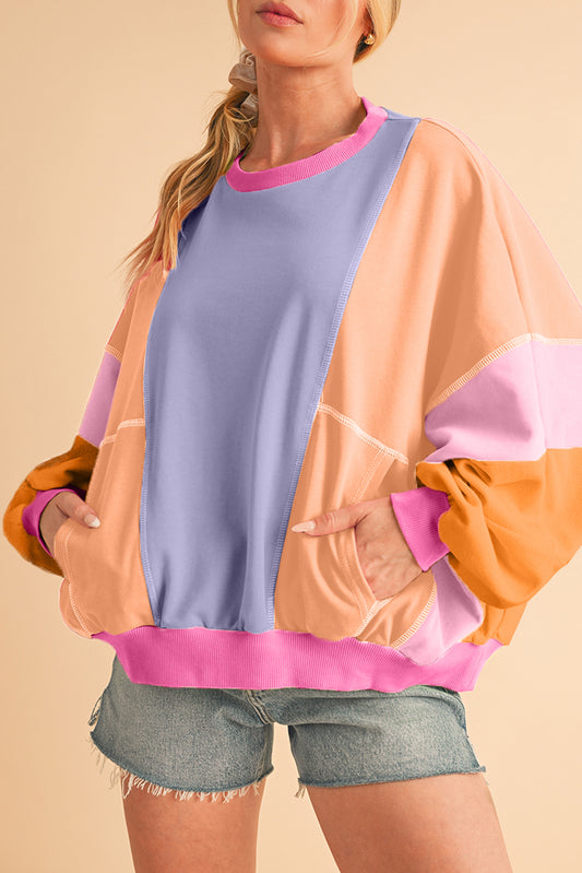 Person wearing a colorful sweater with a beige background