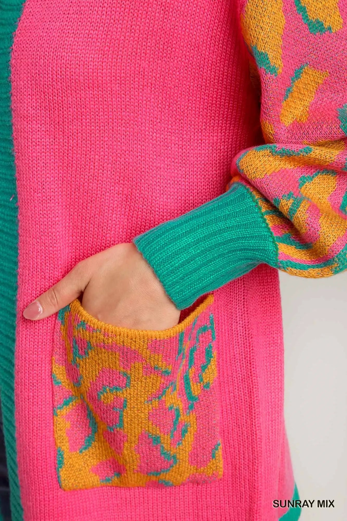 Close-up of the cardigan's pocket showcasing unique patterns.