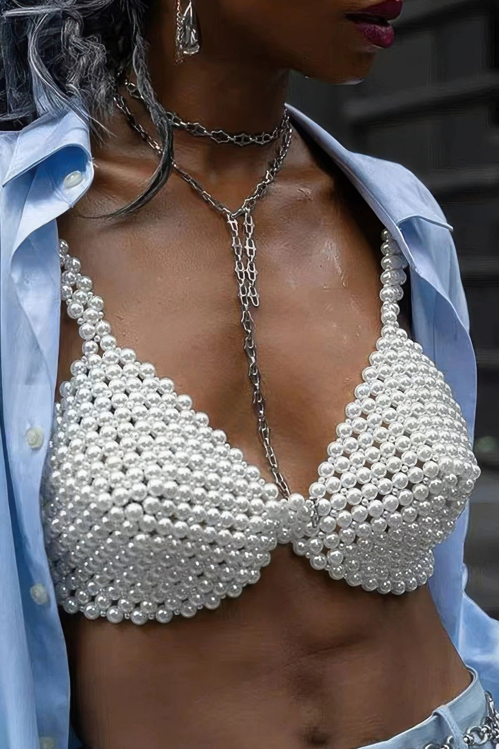 Pearl bralette worn by a person with a blurred background