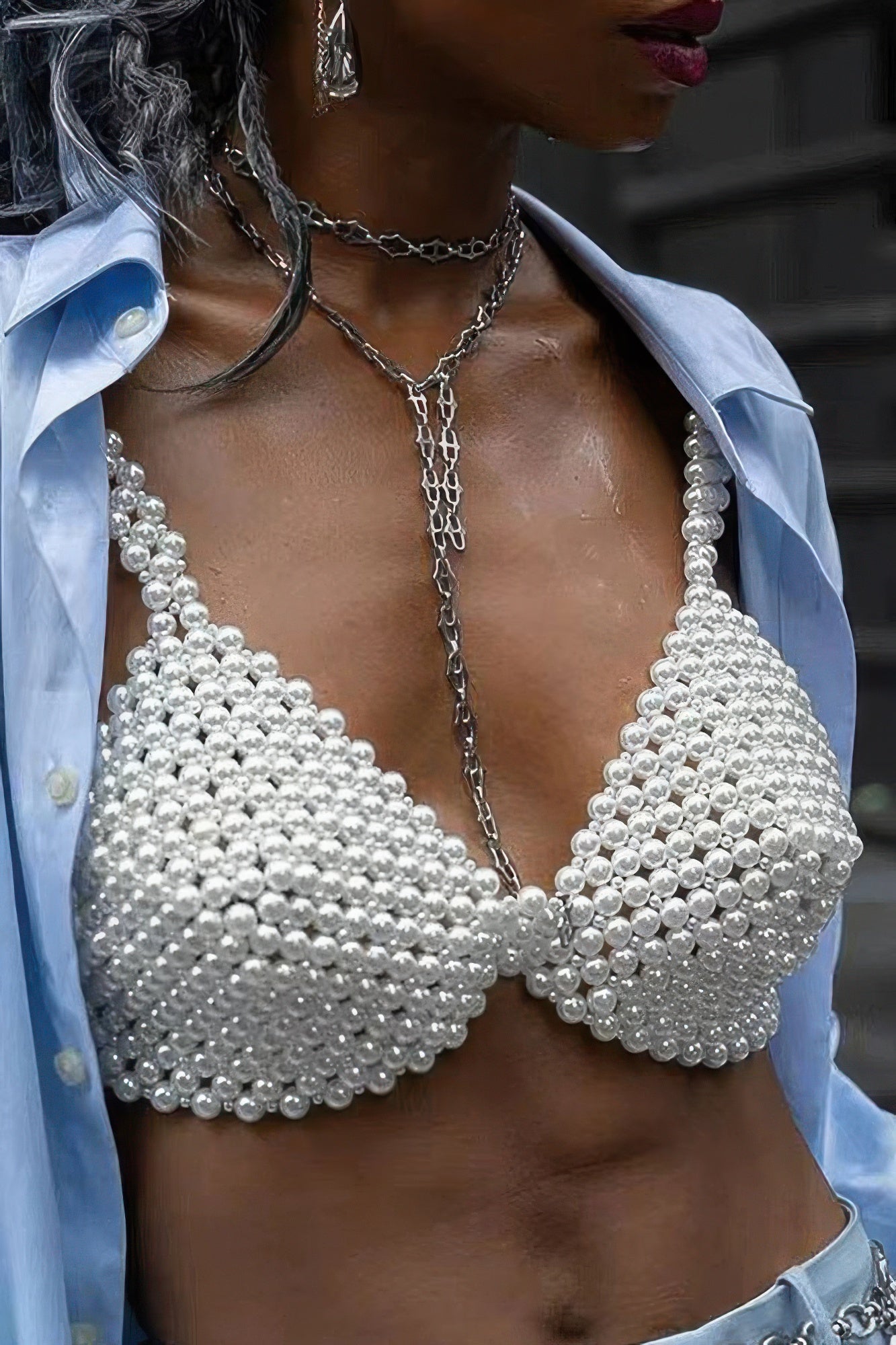 Pearl bralette worn by a person with a blurred background