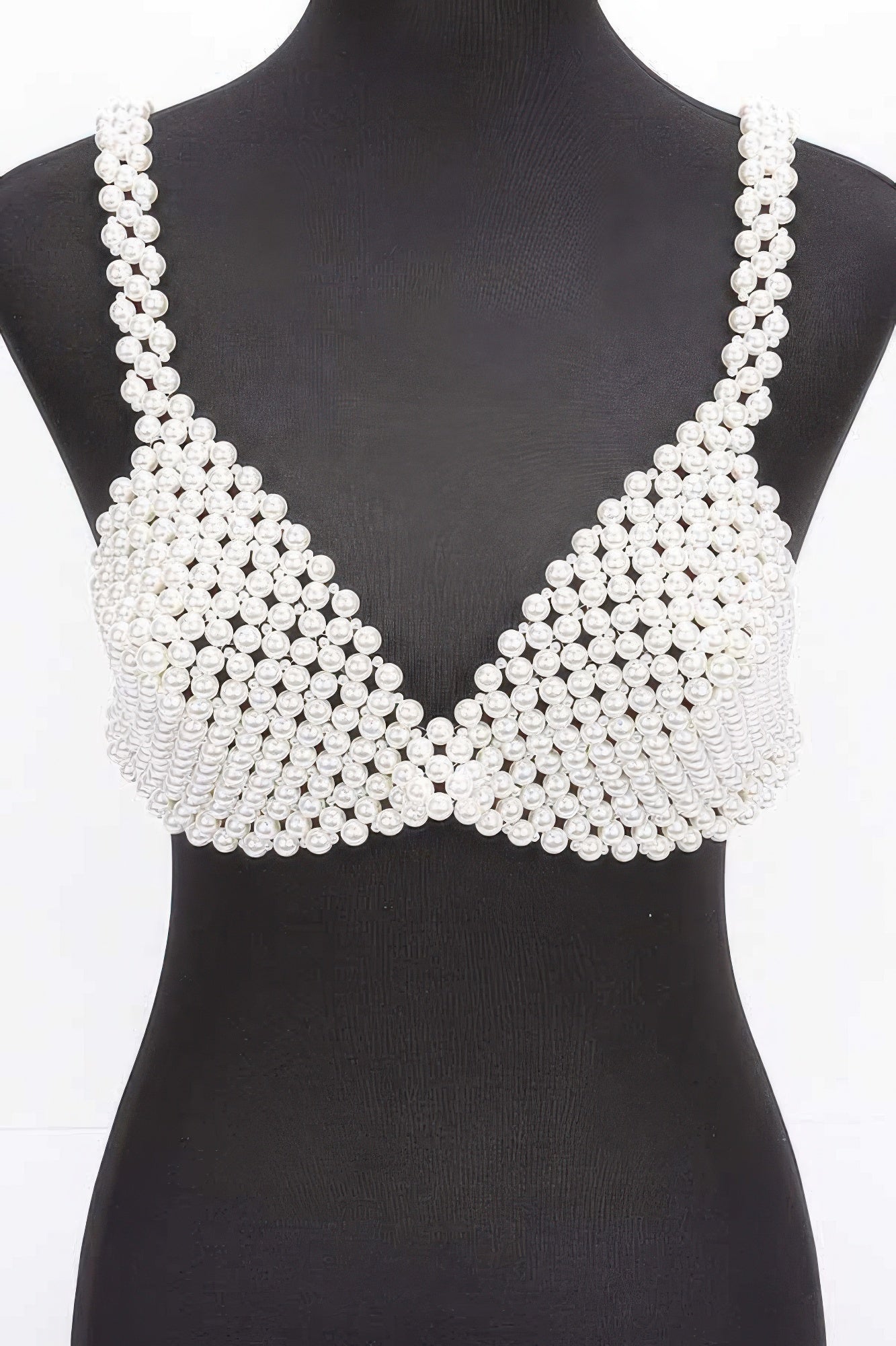 Pearl-studded bralette on a mannequin against a white background