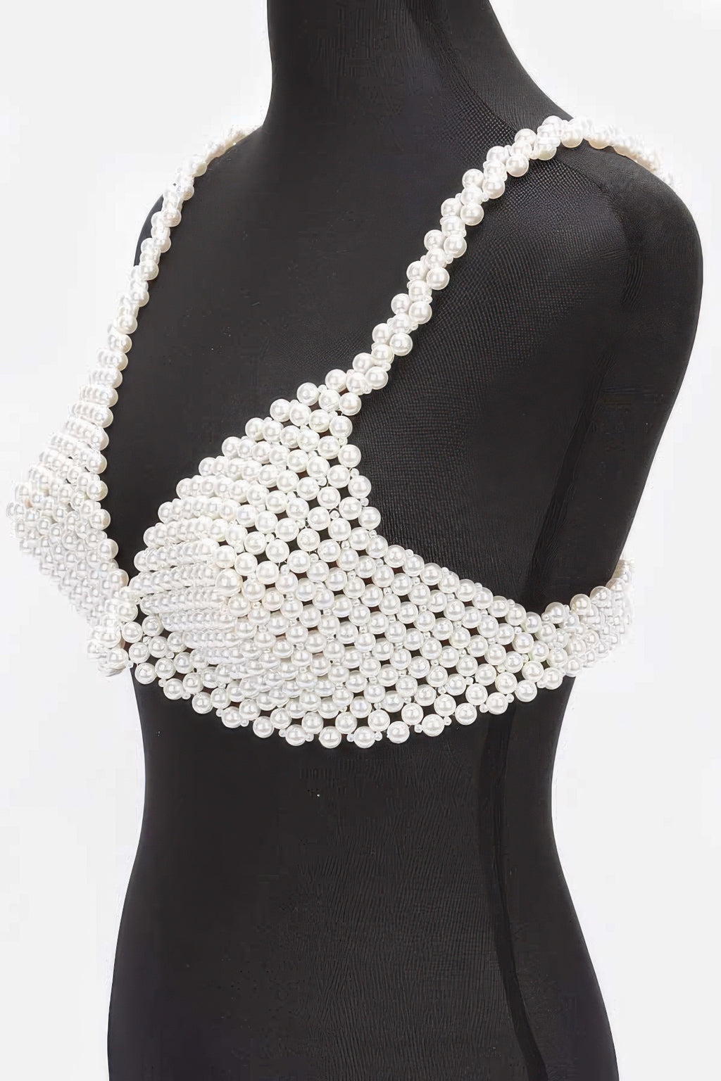 Pearl-studded top on a mannequin against a white background