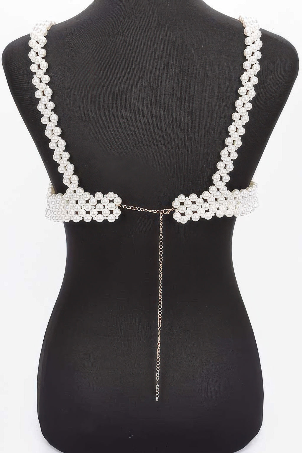 Pearl-like decorative back piece on a black mannequin