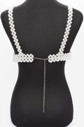 Pearl-like decorative back piece on a black mannequin