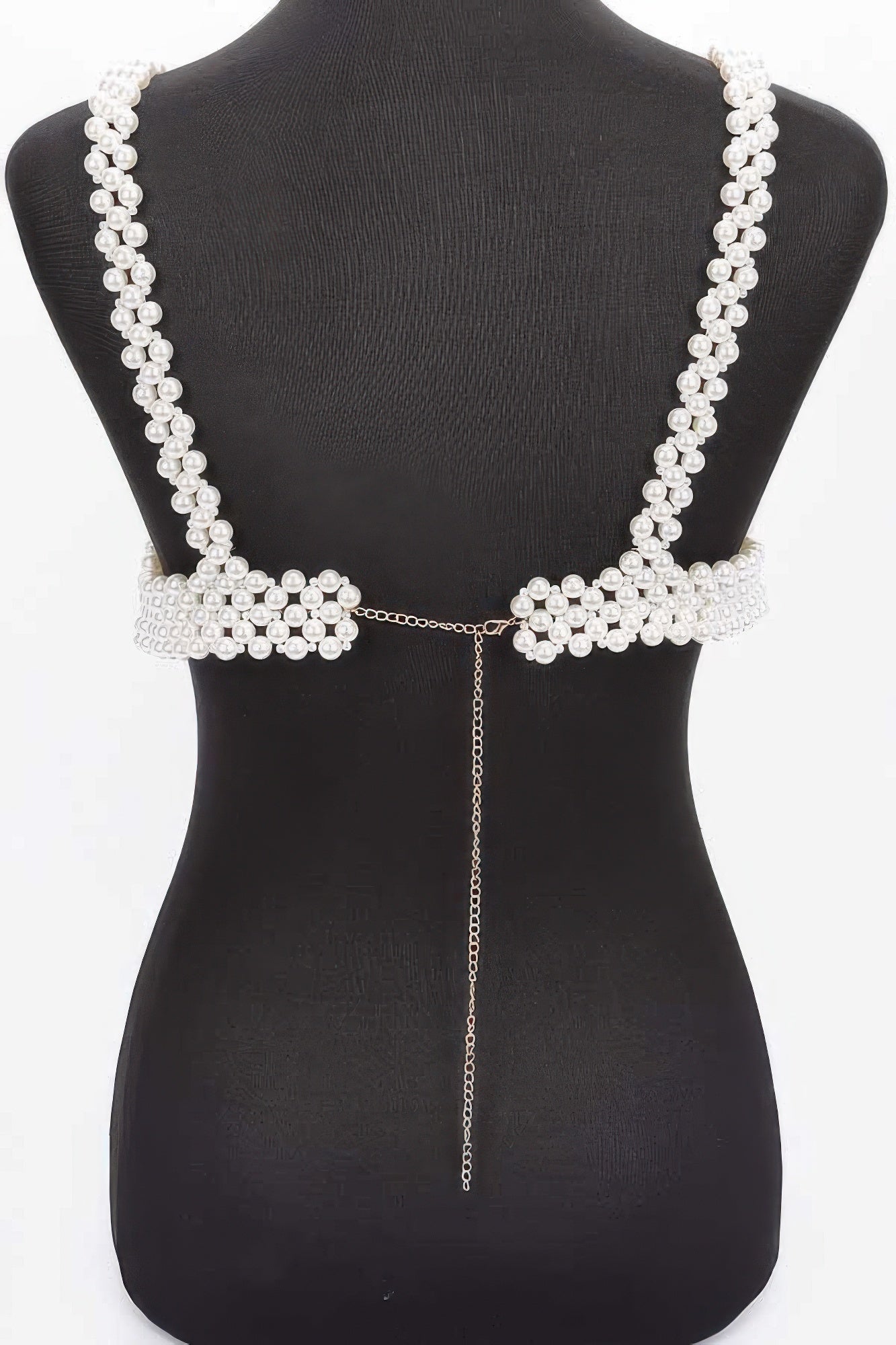 Pearl-like decorative back piece on a black mannequin
