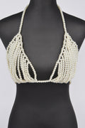 Pearl-beaded bikini top on a black mannequin against a white background