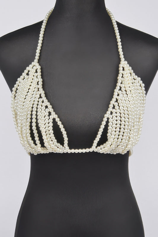 Pearl-beaded bikini top on a black mannequin against a white background
