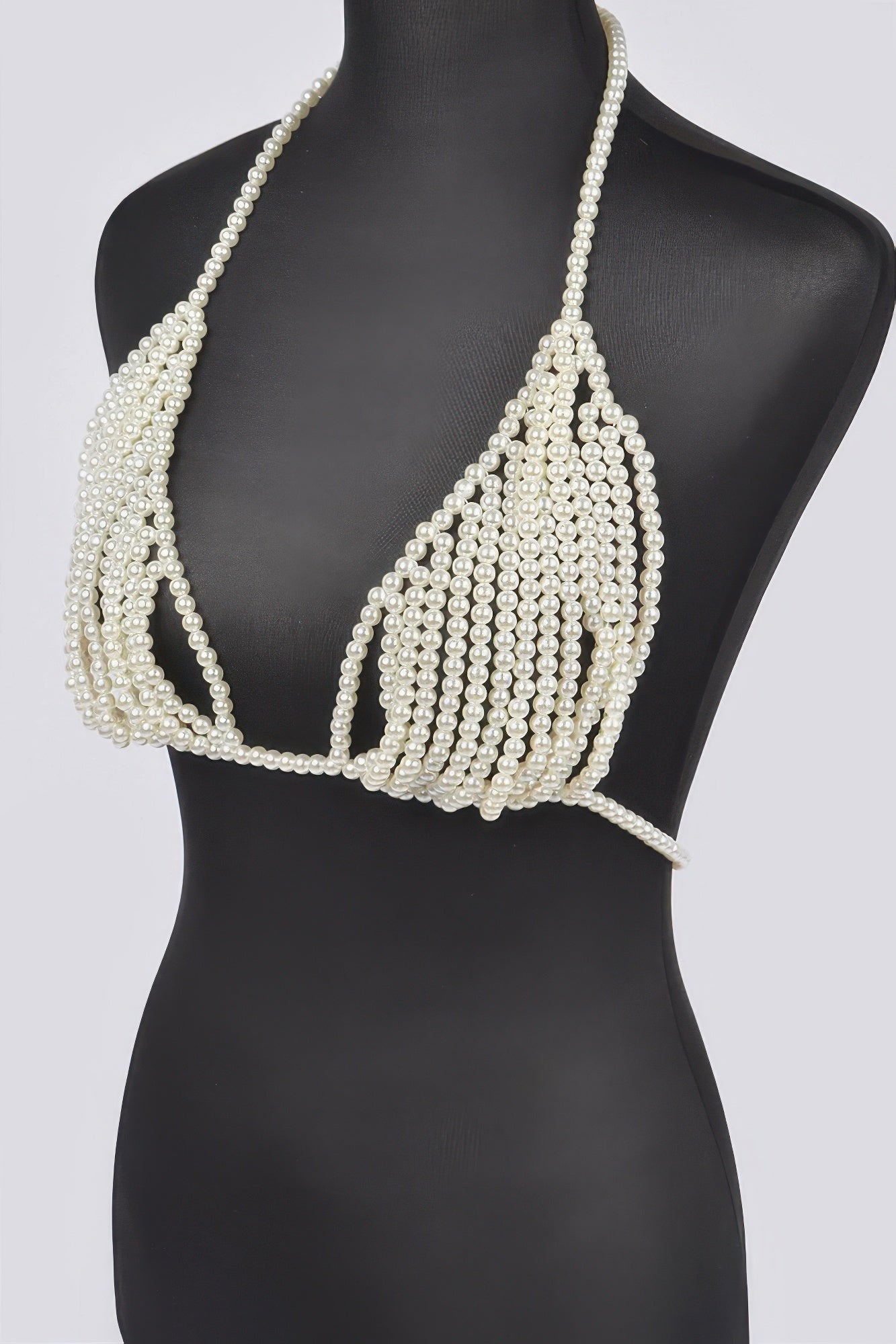 Pearl bikini top on a mannequin against a white background