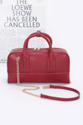 Red handbag with gold chain strap on a white background, featuring text about a show being cancelled.