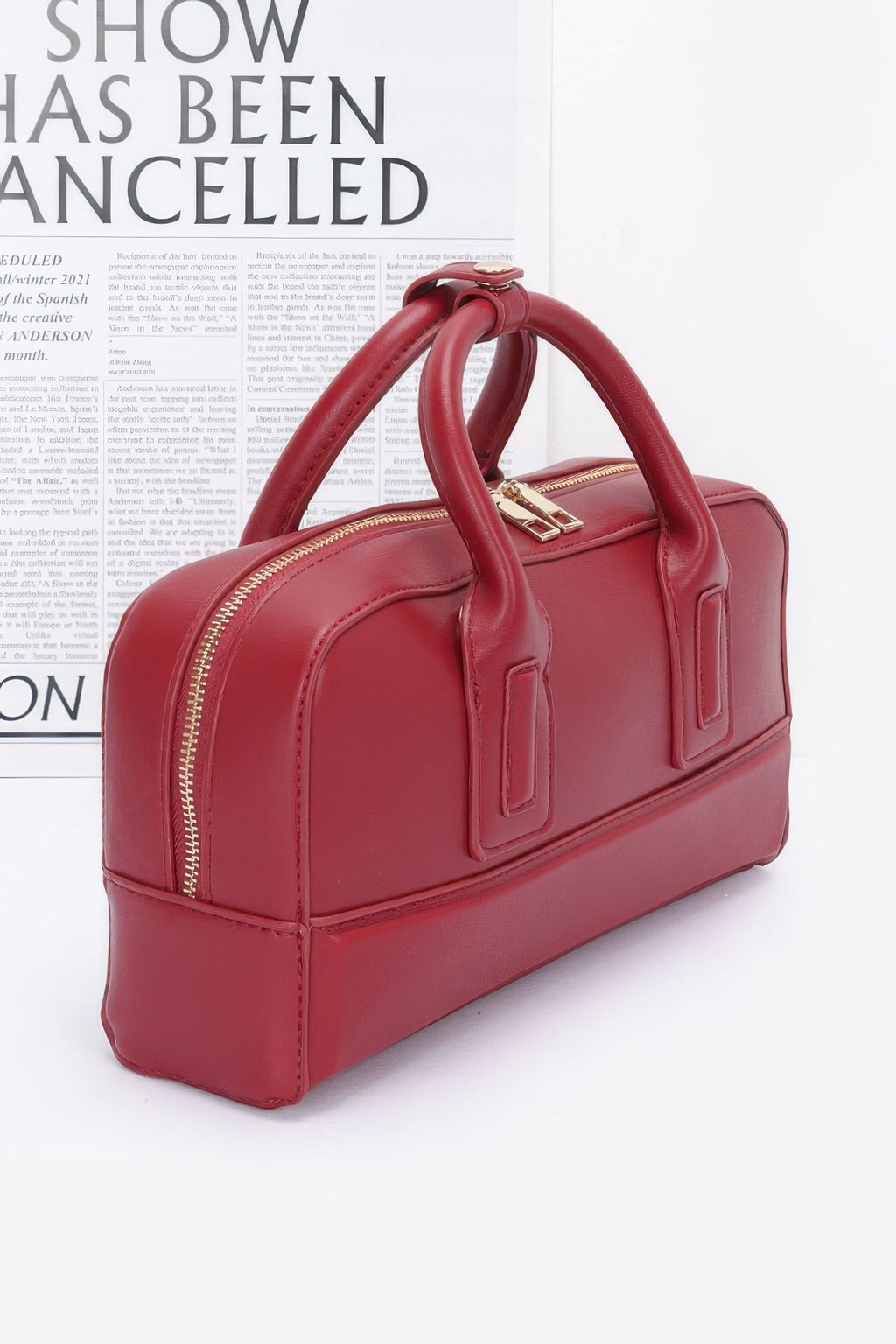 Red handbag on a white background with text overlay side view 