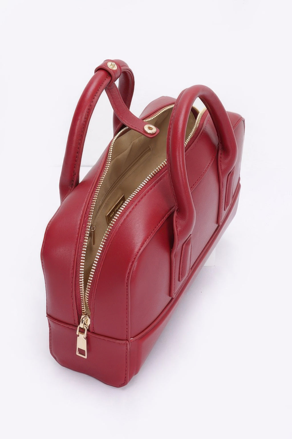 Red handbag with gold zipper on a white background open view