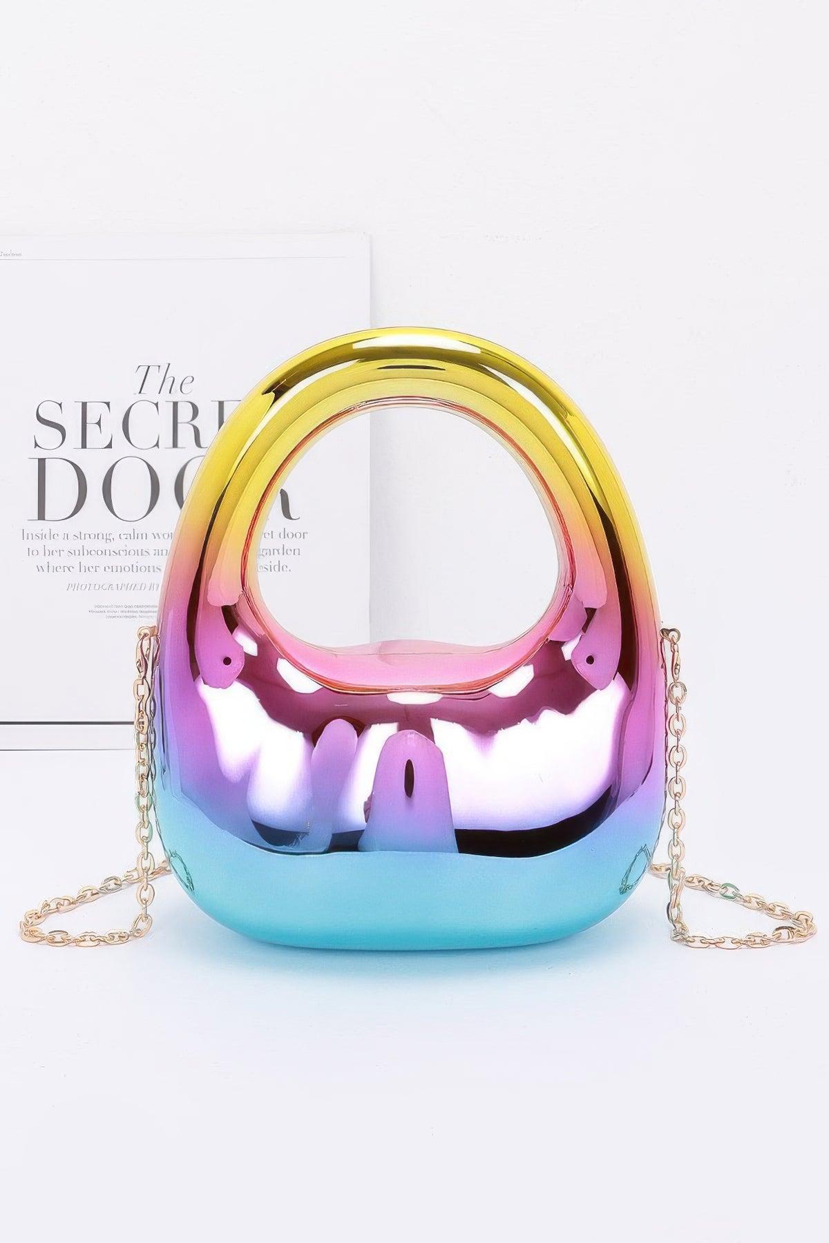 Multicolored metallic handbag with a chain strap on a white background