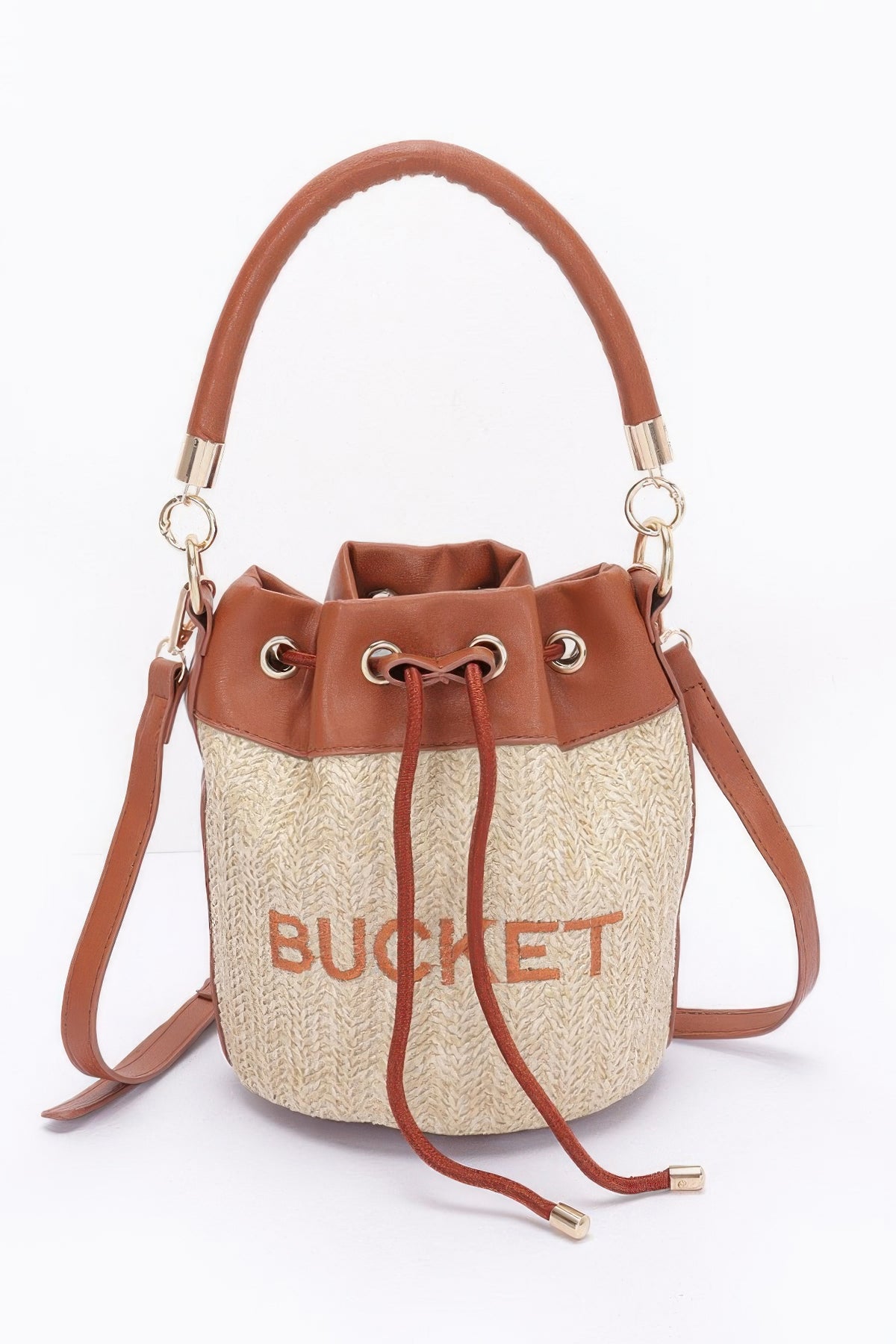 Bucket bag with brown leather top handle and strap on a white background
