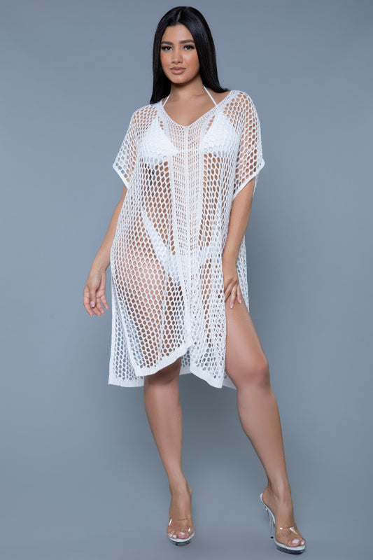 Woman wearing a white crochet cover-up against a gray background front view