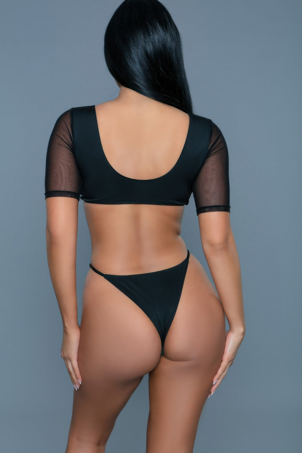 Person wearing a black bikini set on a gray background