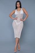 Woman wearing a white lace dress against a gray background front view