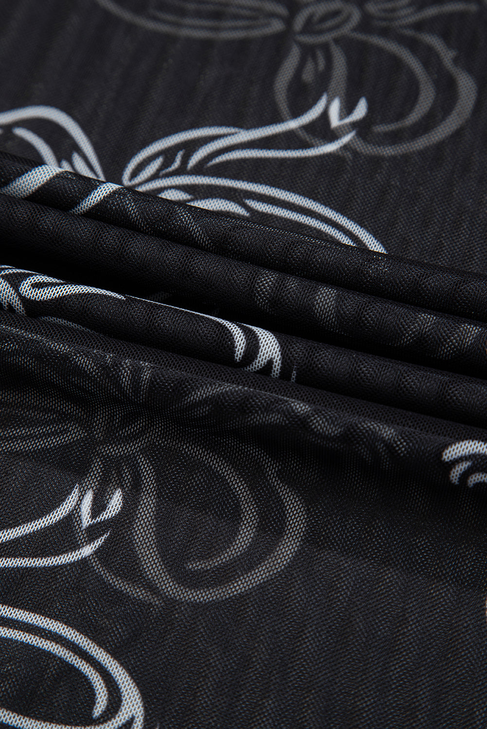 Close-up of black fabric with white floral patterns