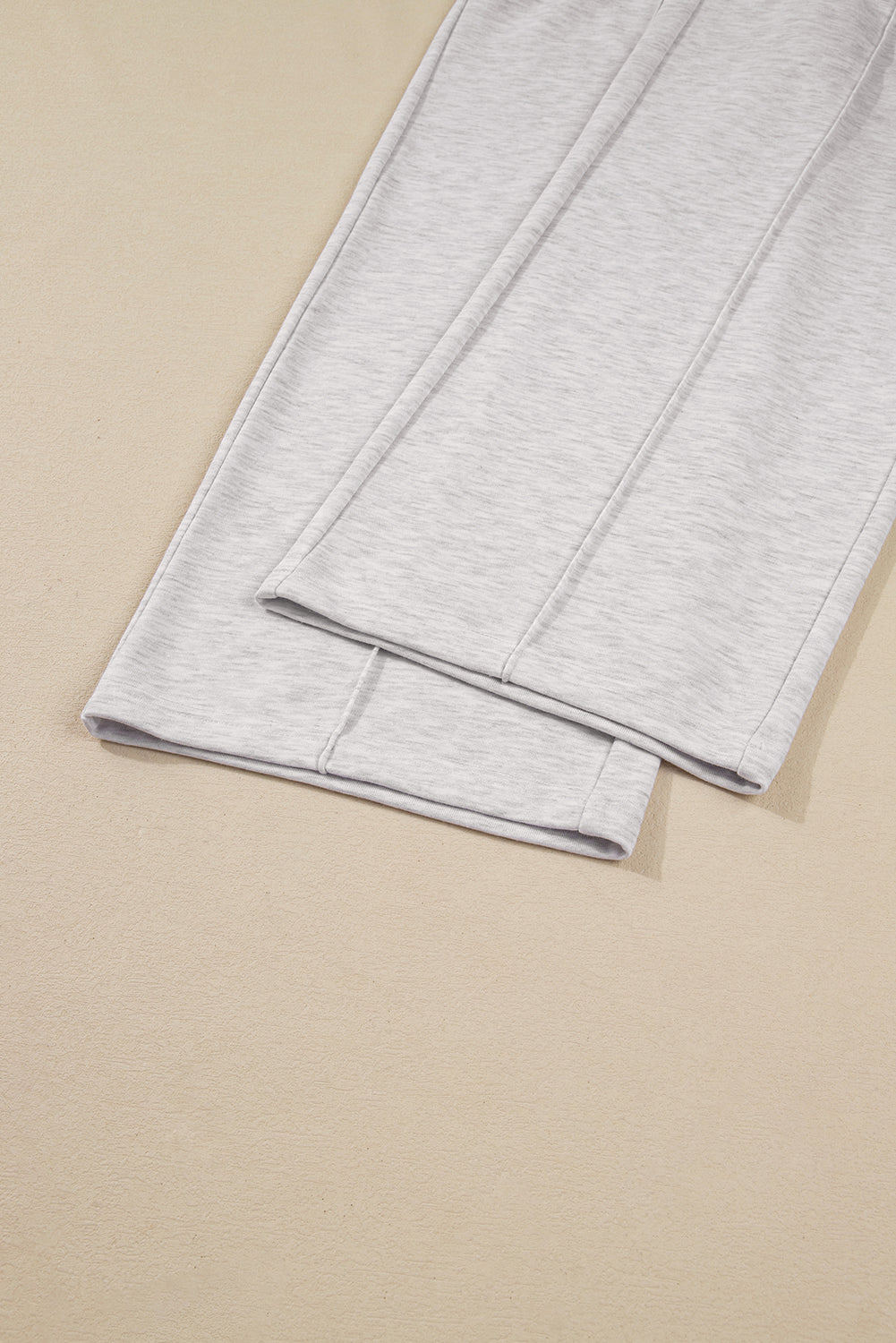 Folded gray fabric on a beige background