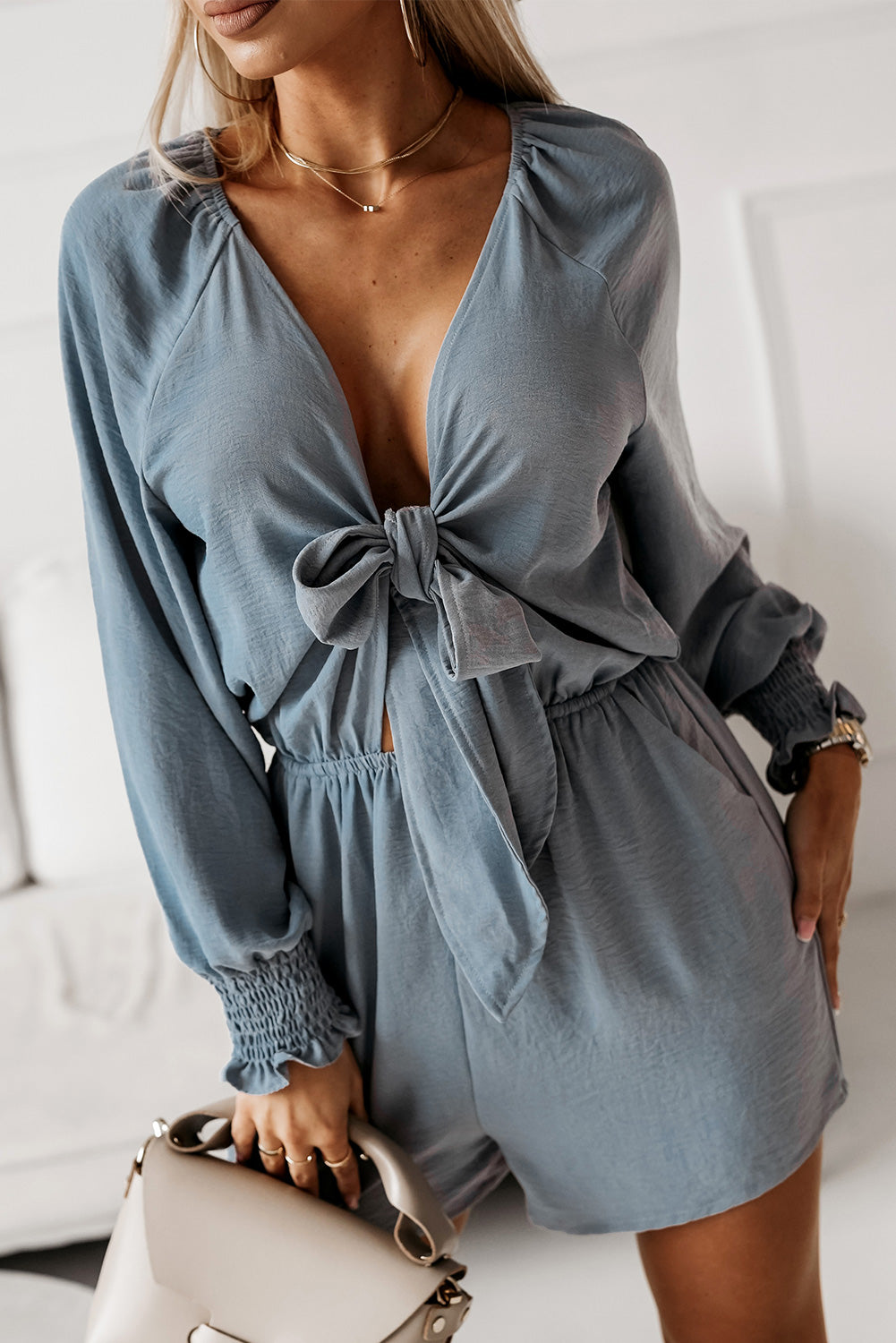 A model wearing a Cloudy Blue Ladies Sexy V-Shaped Open Top Flounce Sleeve Plunge Romper Shorts