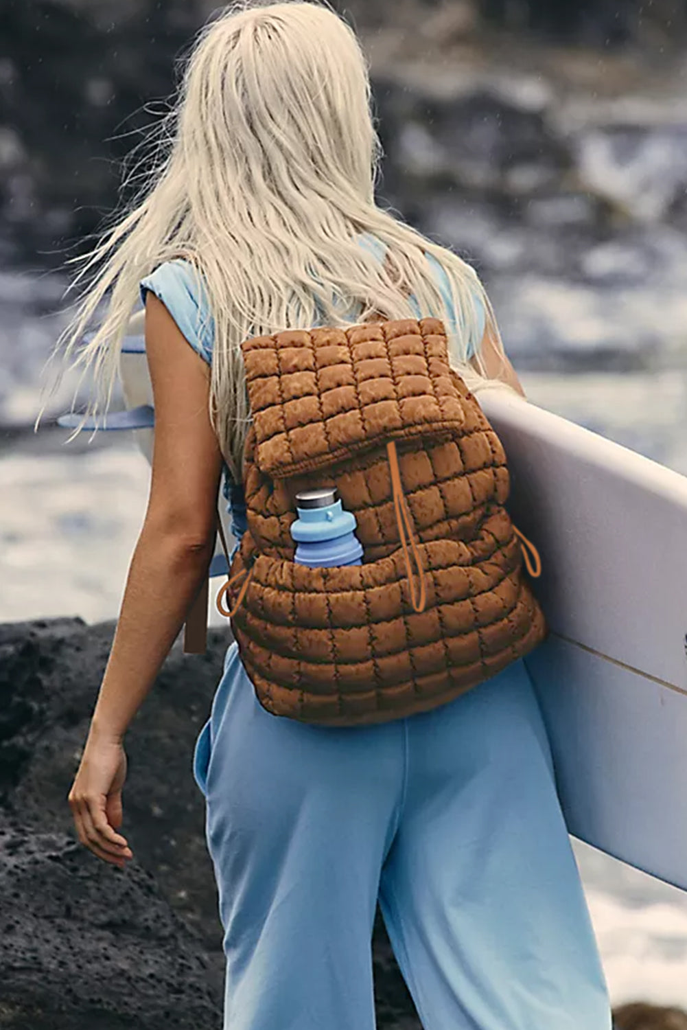 Model wearing a Chic coffee brown Quilted Puffer Flap Backpack across the back