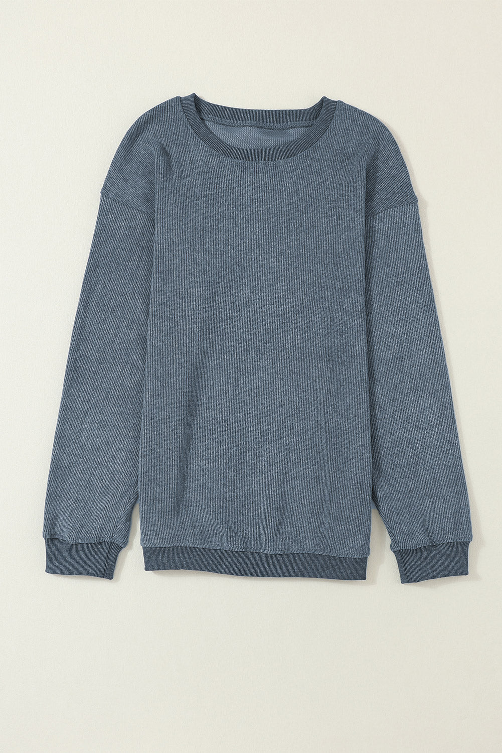 Blue sweater on a beige background