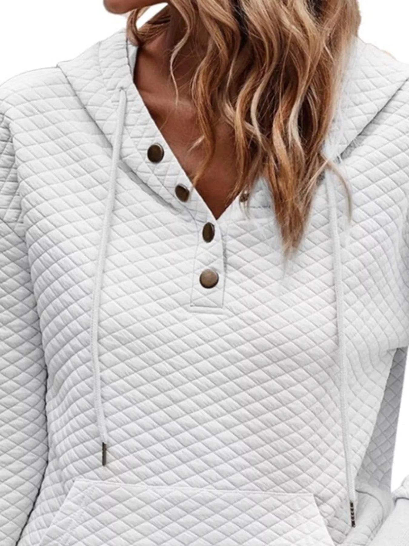White quilted jacket with button details on a white background