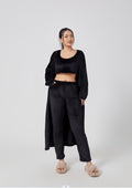 Woman wearing a black outfit on a white background