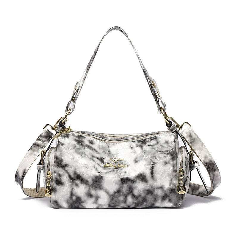 Marble-patterned handbag with gold accents on a white background