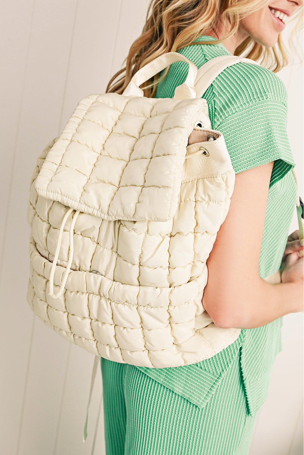 Model wearing a Chic white Quilted Puffer Flap Backpack across the back