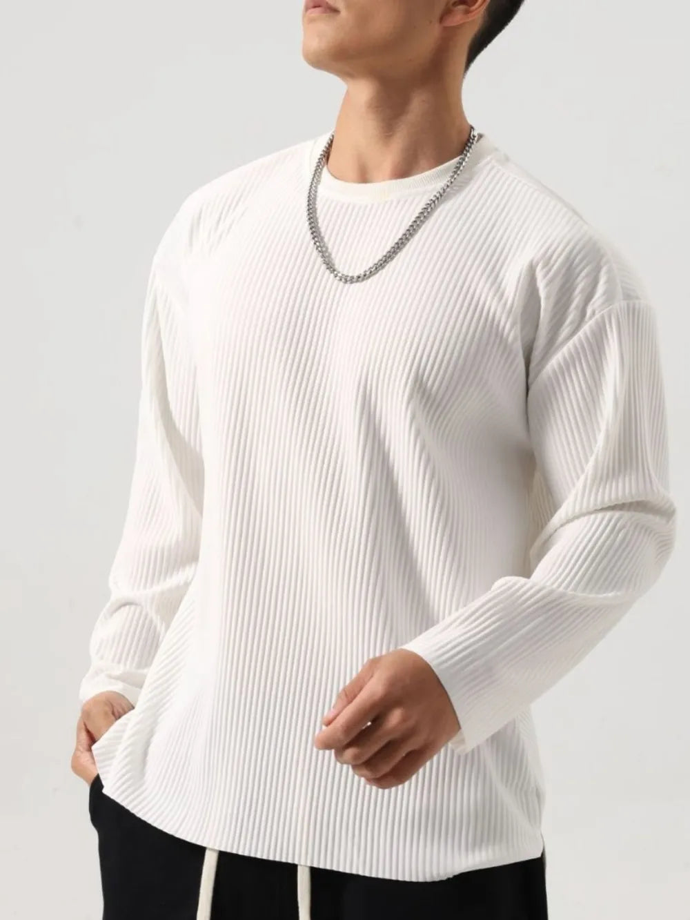 Person wearing a white Men's Basic Ribbed Round Neck Long Sleeve T-Shirt