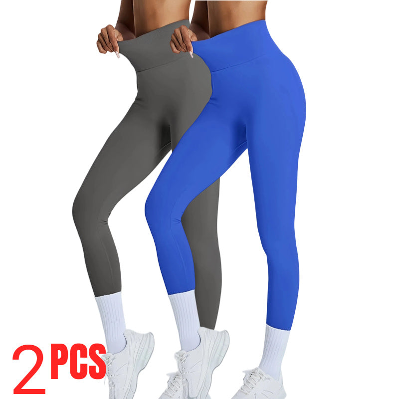 Two pairs of leggings, one gray and one blue, held by a person on a white background.