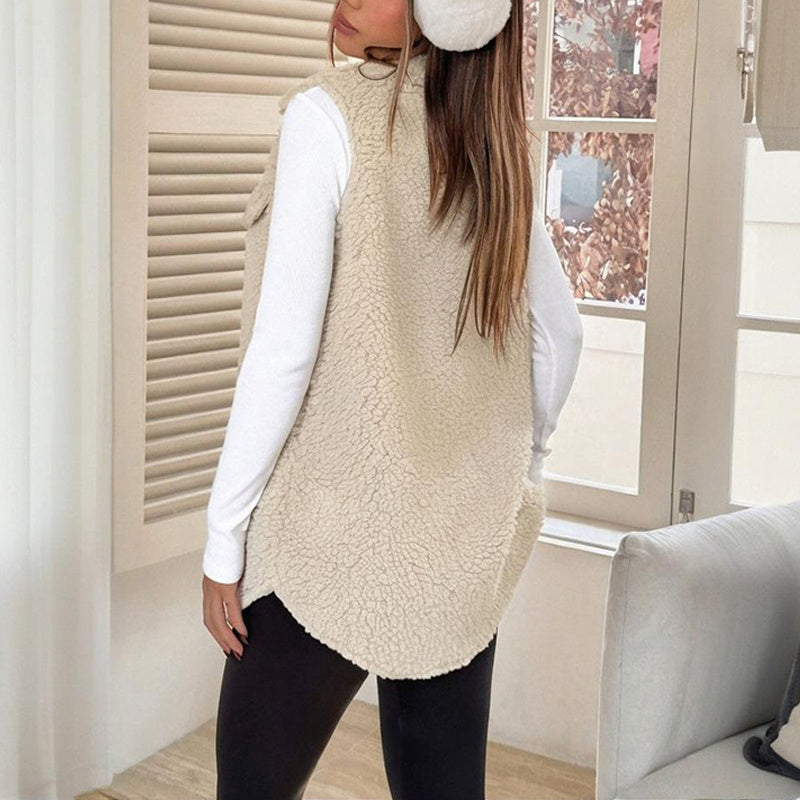 Person wearing a beige fleece vest indoors