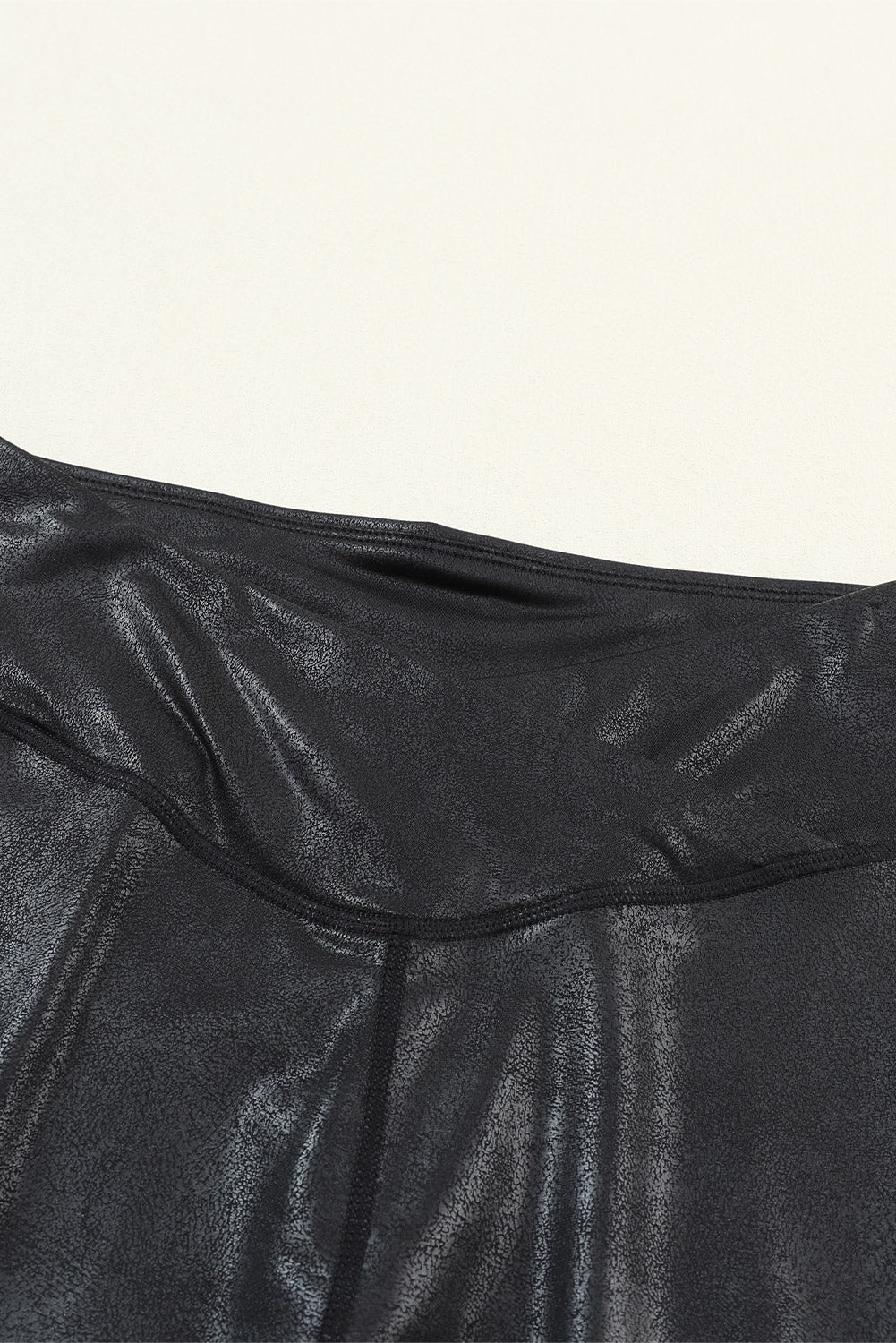 Close-up of a black leather garment on a white background