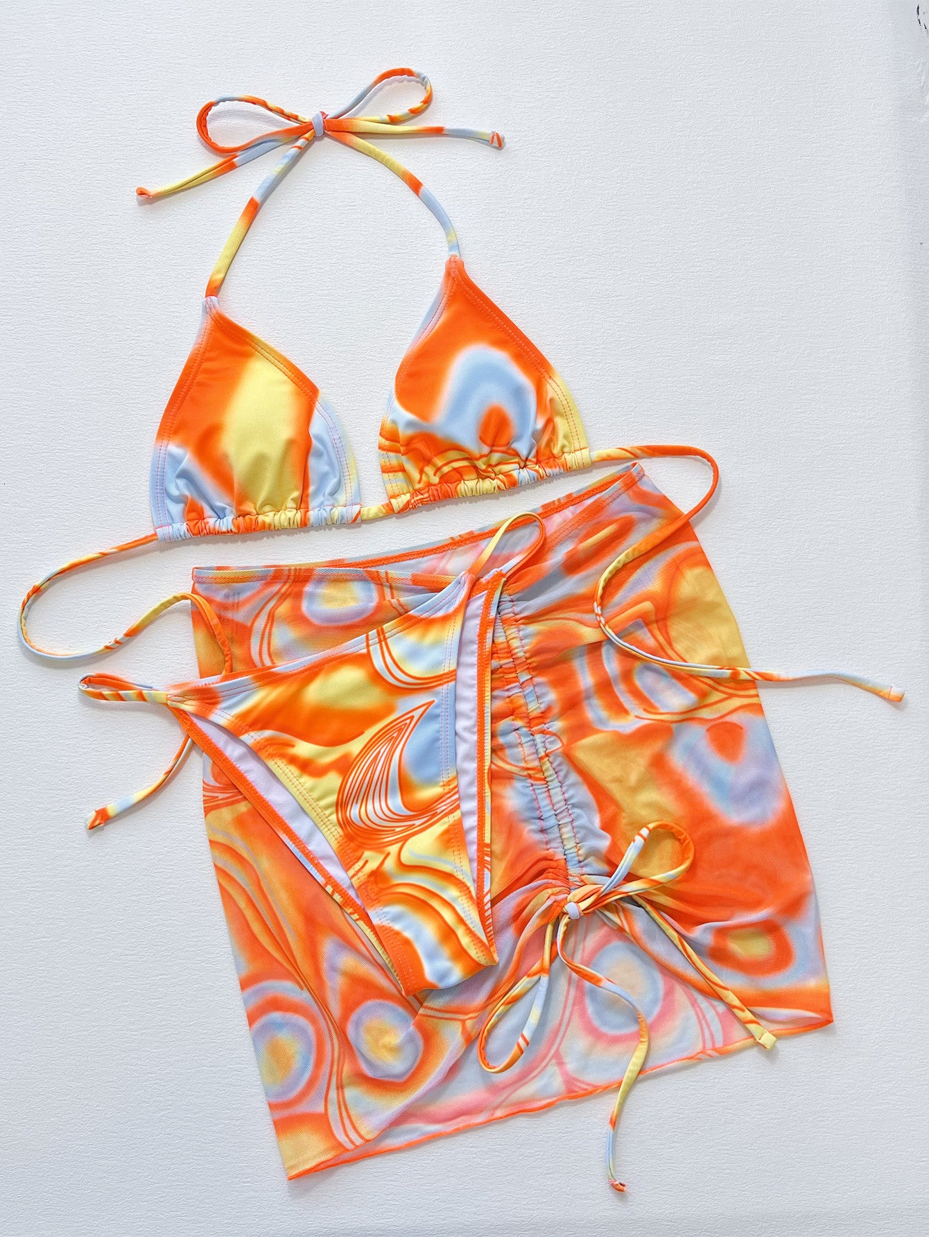Colorful bikini set with orange, yellow, and blue pattern on a white background