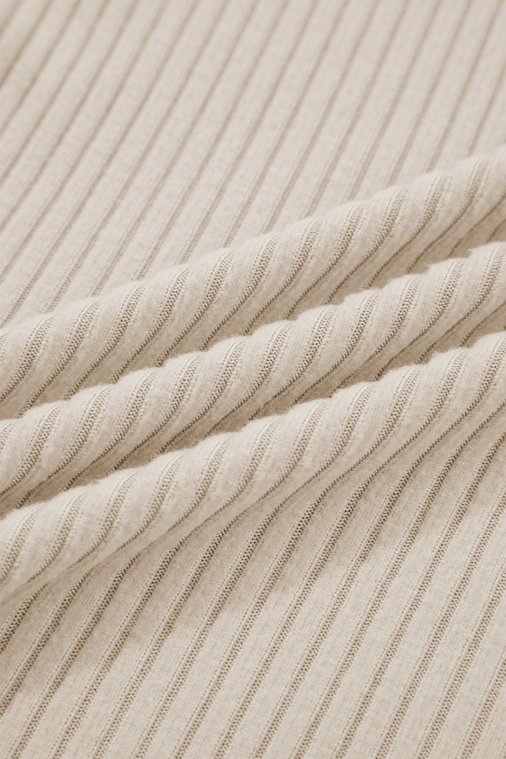 Close-up of beige ribbed fabric with horizontal stripes