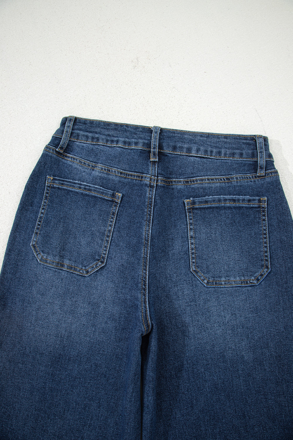 Blue jeans shown from the back on a white background