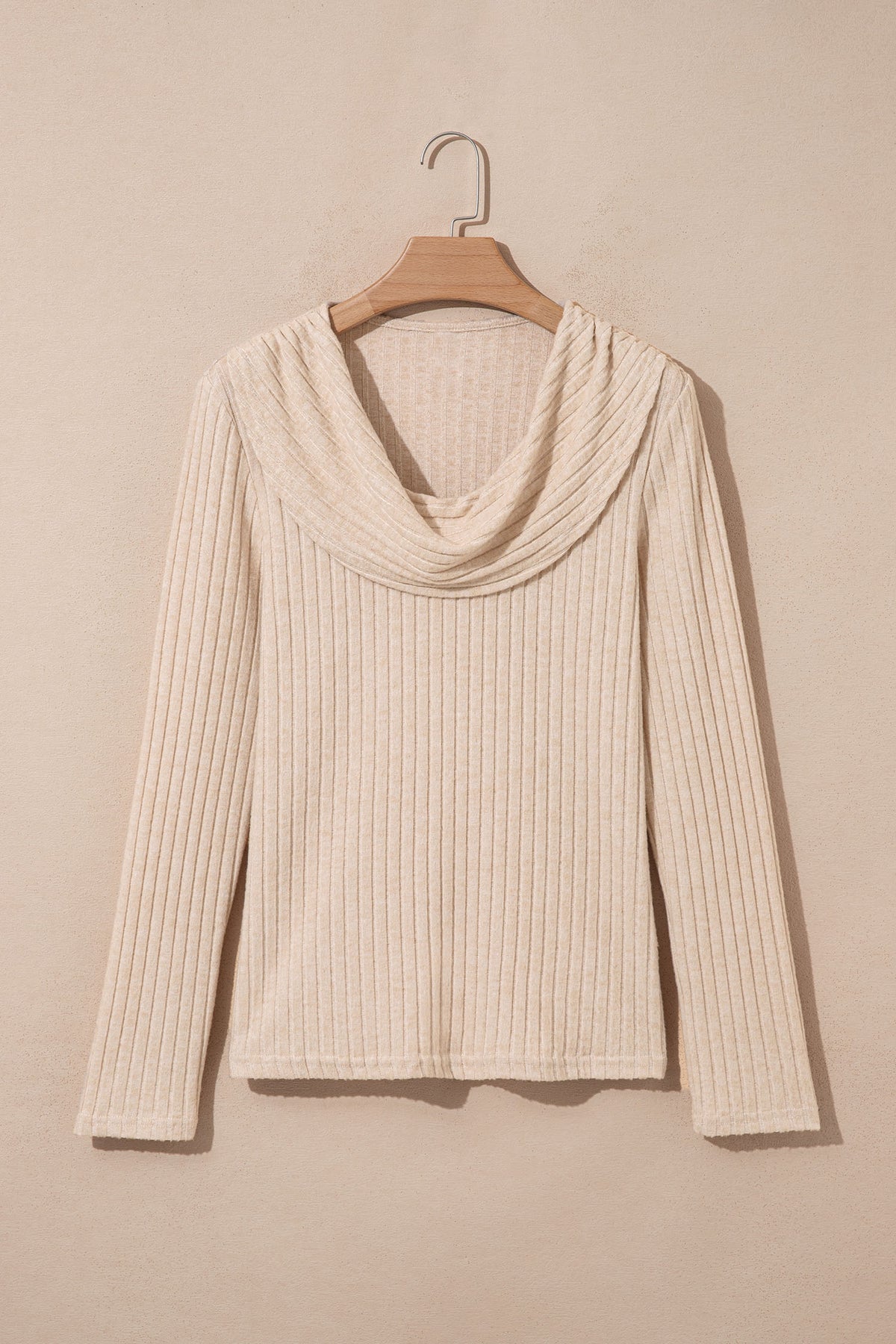 A Ribbed Cowl Neck Women's Blouse in apricot hanging on a wooden hanger front view