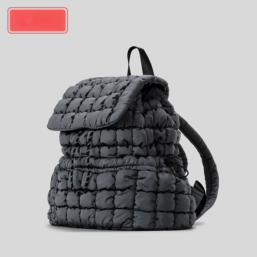 Gray quilted backpack on a light gray background