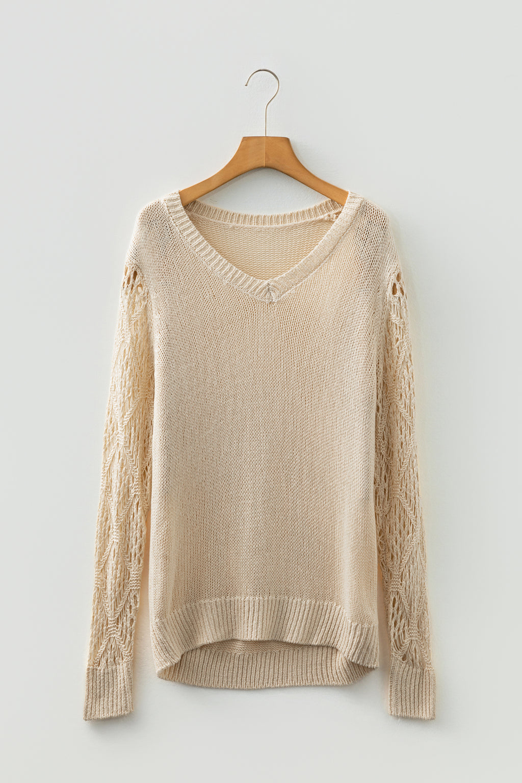 Beige Women's Pointelle Knit V-Neck Sweater on a wooden hanger front view