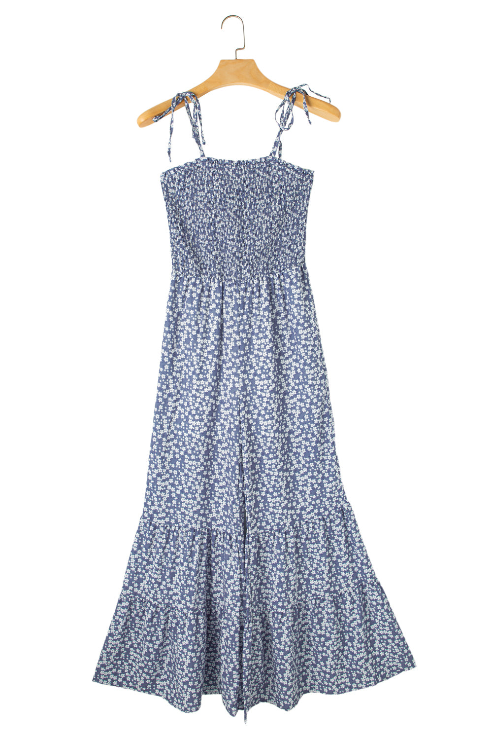 Blue floral dress on a hanger against a white background