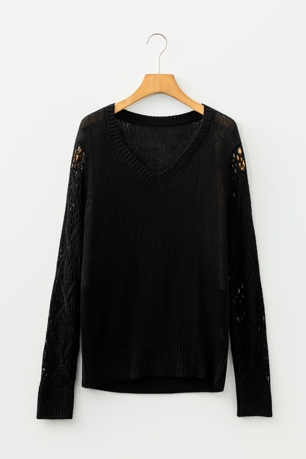 Black Women's Pointelle Knit V-Neck Sweater on a wooden hanger front view