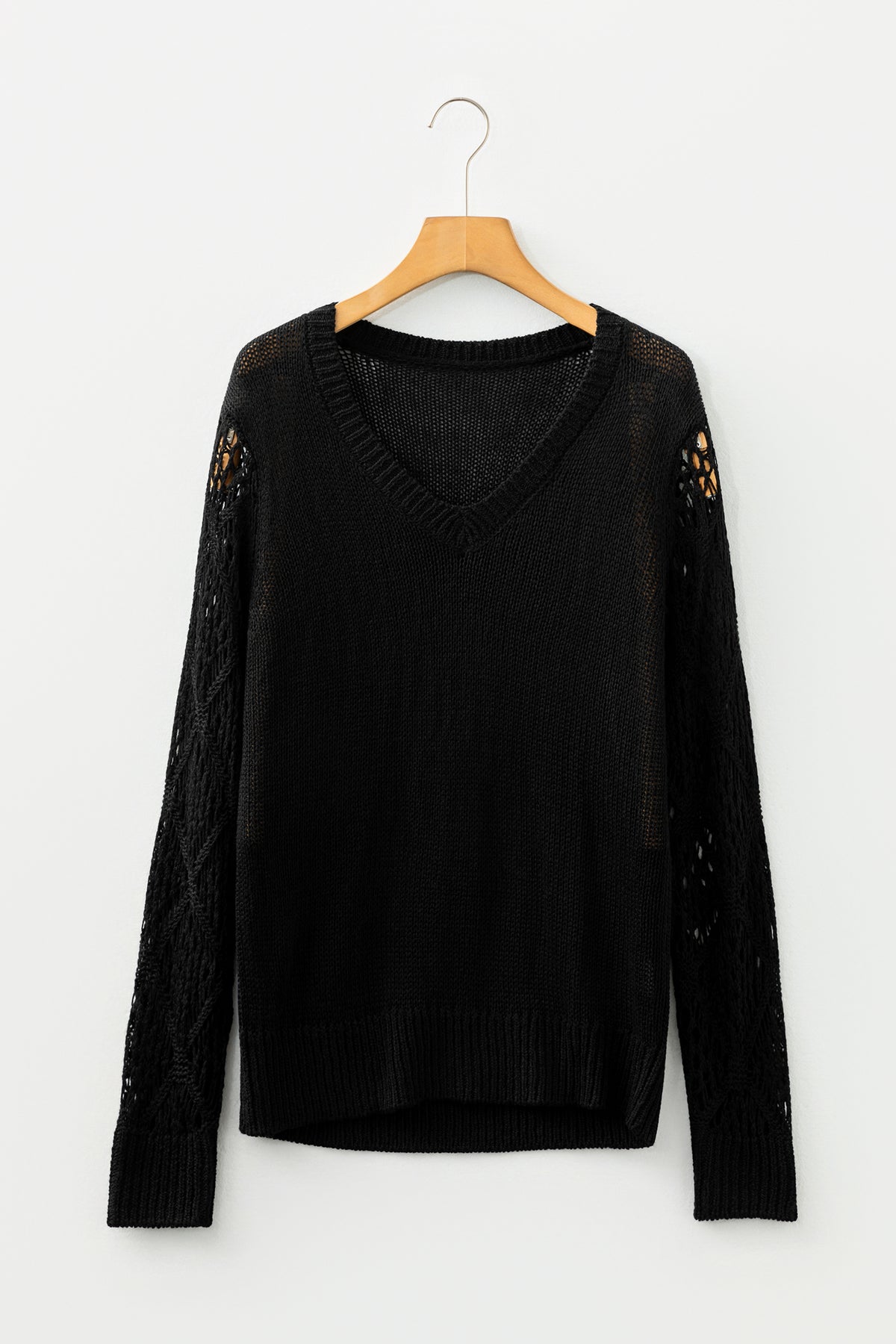 Black Women's Pointelle Knit V-Neck Sweater on a wooden hanger front view