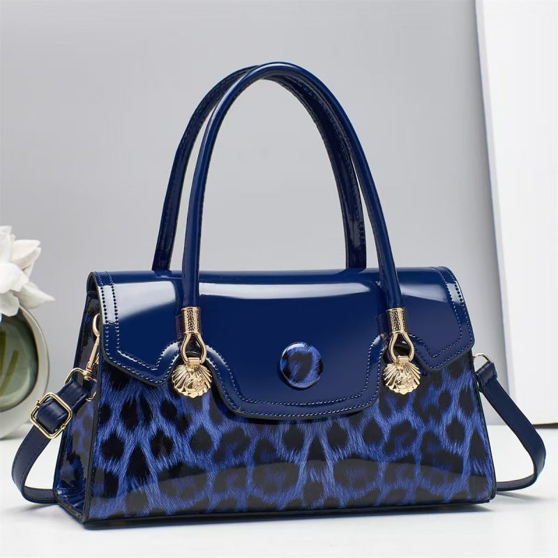 Blue handbag with gold accents on a light gray background