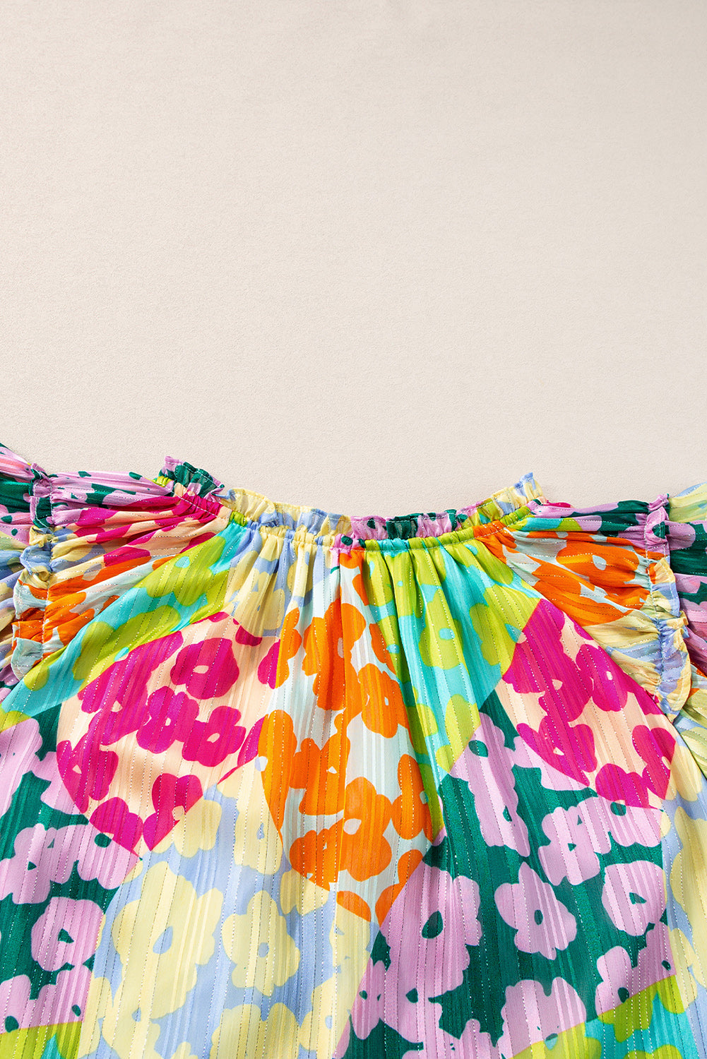 Colorful floral skirt with ruffled top on a beige background