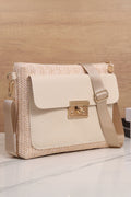 Beige handbag with gold accents on a wooden surface