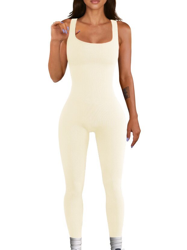 Woman wearing a cream-colored sleeveless jumpsuit on a white background
